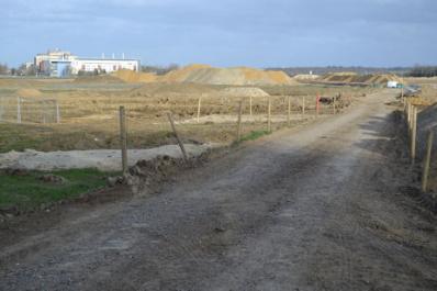 Looking across Clay Farm along the track from the allotments to the railway, with construction underway for the spine road and the largest pond, with Addenbrooke’s in the distance. Photo: Andrew Roberts, 10 March 2011.