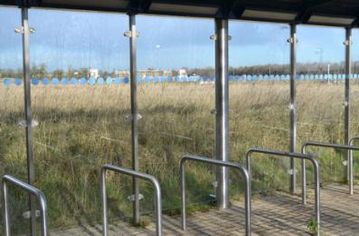 Looking through the busway cycle shelter across the Virido site, Clay Farm, 8 December 2014.