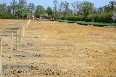 Looking north across the Clay Farm field to the rear of Long Road, with fencing marking the line of the spine road. Photo: Andrew Roberts, 10 April 2011.