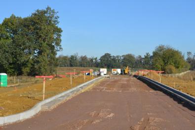 Looking south and north along the spine road from the track, Clay Farm. Photo: Andrew Roberts, 29 October 2011.