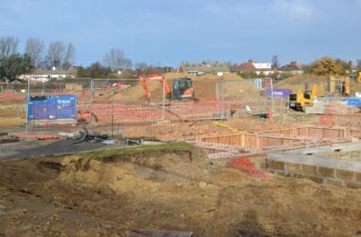 Construction work on new homes along Glebe Farm Drive, with the established homes on Bishop�s Road in the background, Novo development, Glebe Farm. Photo: Andrew Roberts, 8 December 2013.