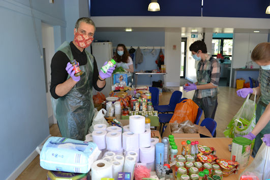 Claude Grewal-Sultze and other volunteers setting up Trumpington Food Hub in Trumpington Pavilion. Photo: Andrew Roberts, 19 May 2020.