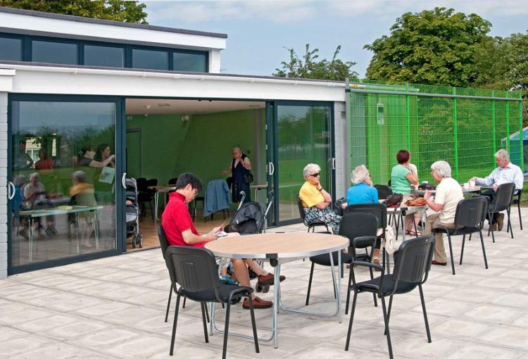 Trumpington Pavilion Open Day: participants on the patio and inside the hall, looking through the open patio doors, 8 August 2009. Photo: Stephen Brown.
