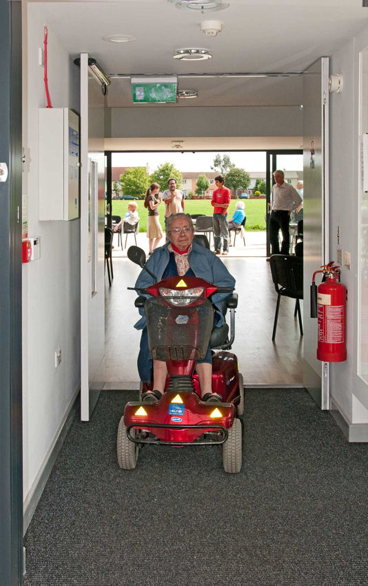 Trumpington Pavilion Open Day: visitor with buggy leaving through the foyer, 8 August 2009. Photo: Stephen Brown.