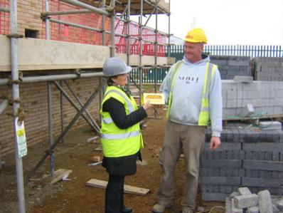 Preparing to place one of the golden bricks on a Trumpington Meadows home, with Caroline Wright, April 2012. Photo: Nick Milne.