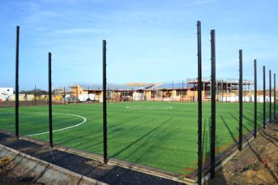 Progress with the construction of Trumpington Meadows School, seen across the newly-laid pitch. Photo: Andrew Roberts, 15 December 2012.